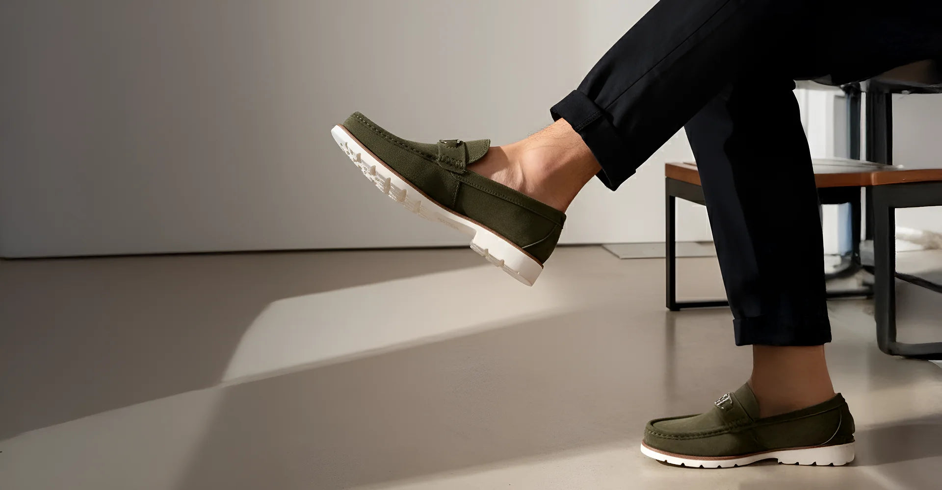 Person wearing green shoes with white soles on a neutral background